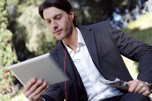 Free Man In Black Suit Jacket Holding A Gadget Stock Photo
