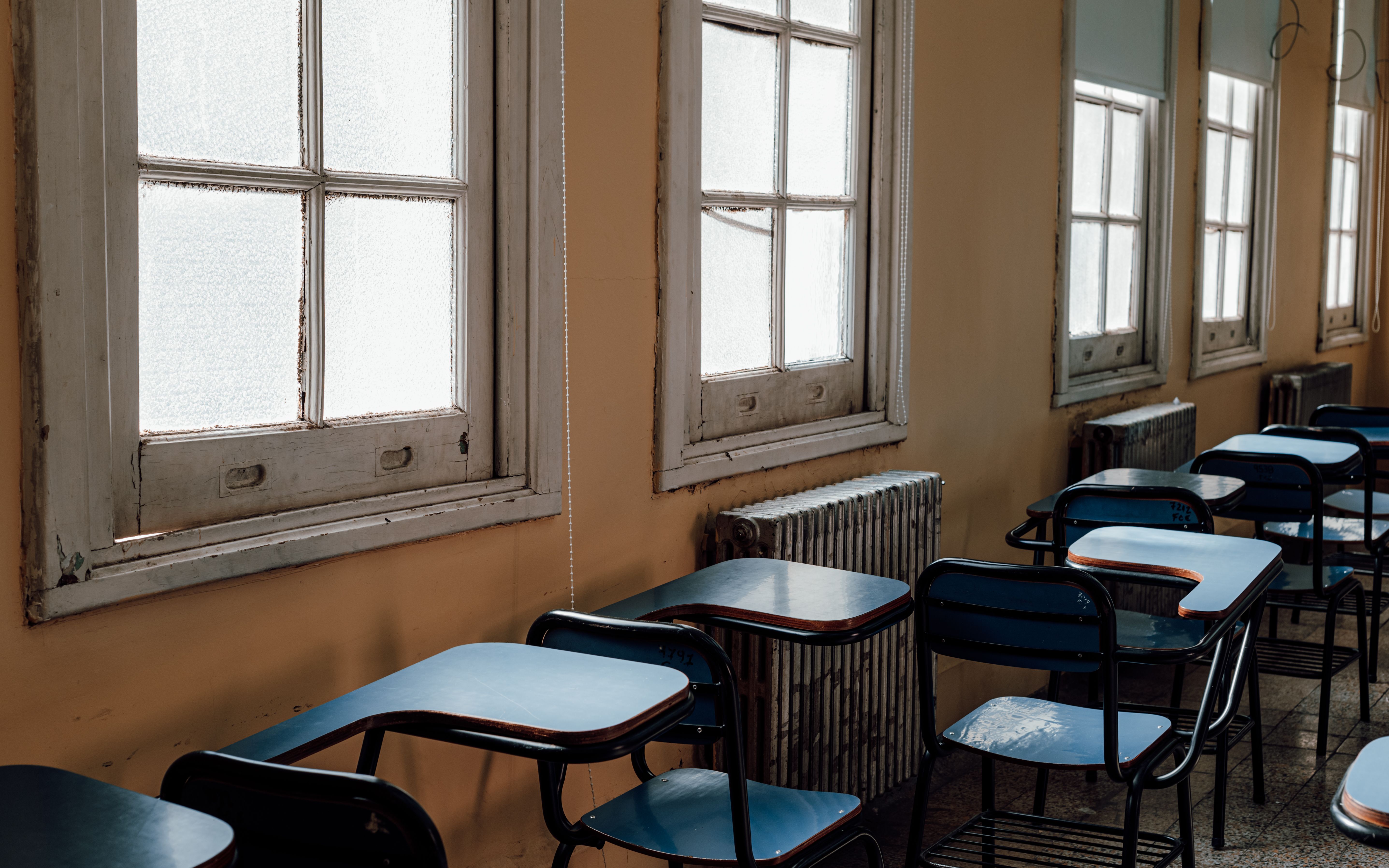 vintage school desk with carved initials, abandoned setting