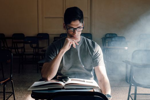 Student reading a book in a sunlit classroom in Buenos Aires. Perfect for educational themes.