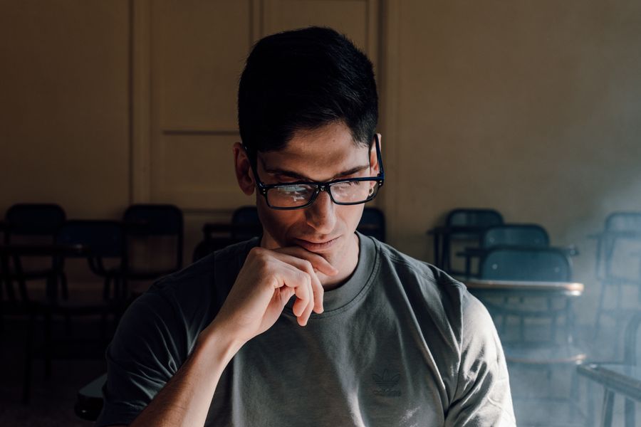 Portrait of a student deep in thought within a classroom in Buenos Aires.