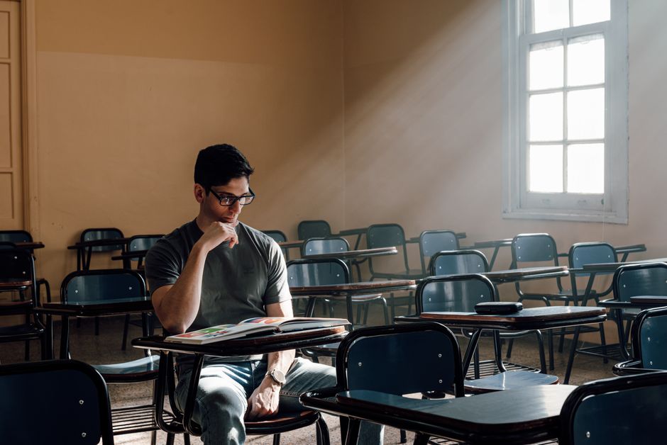 A student studies alone in a sunlit Buenos Aires classroom, portraying university life. A student studies alone in a sunlit Buenos Aires classroom, portraying university life.