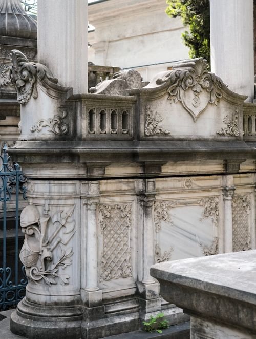 Free Antique stone structure with intricate carvings in an outdoor cemetery setting. Stock Photo
