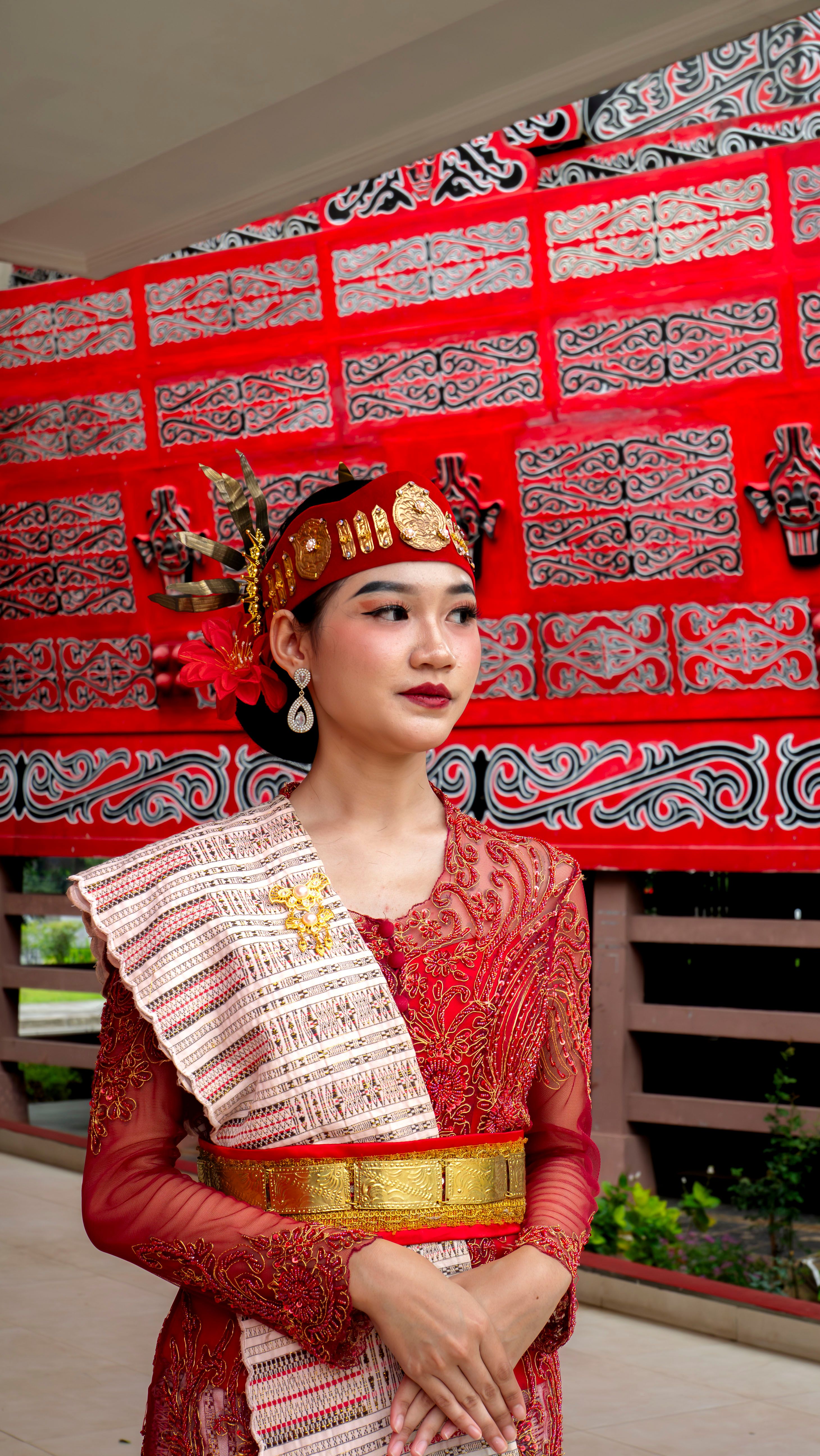 Young woman in traditional Indonesian clothing with ornate headpiece in Jakarta.