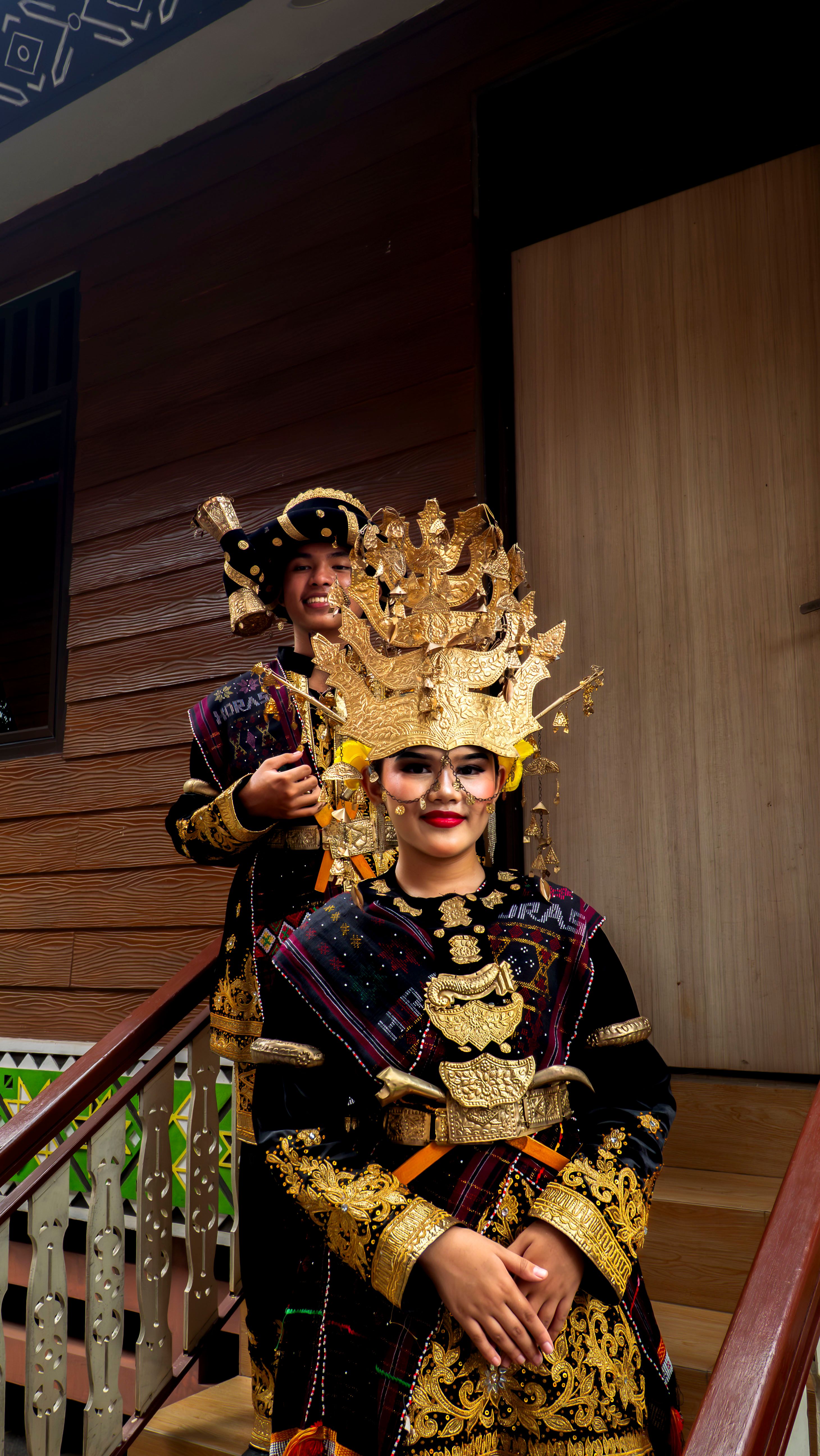 Two people wearing traditional Betawi costumes during a cultural ceremony in Jakarta, Indonesia.