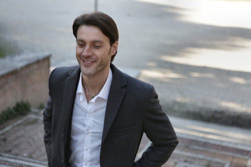 Man In Black Suit Jacket Smiling