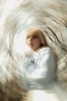 Creative portrait with swirling blur effect, capturing motion and emotion. Unique artistic style.