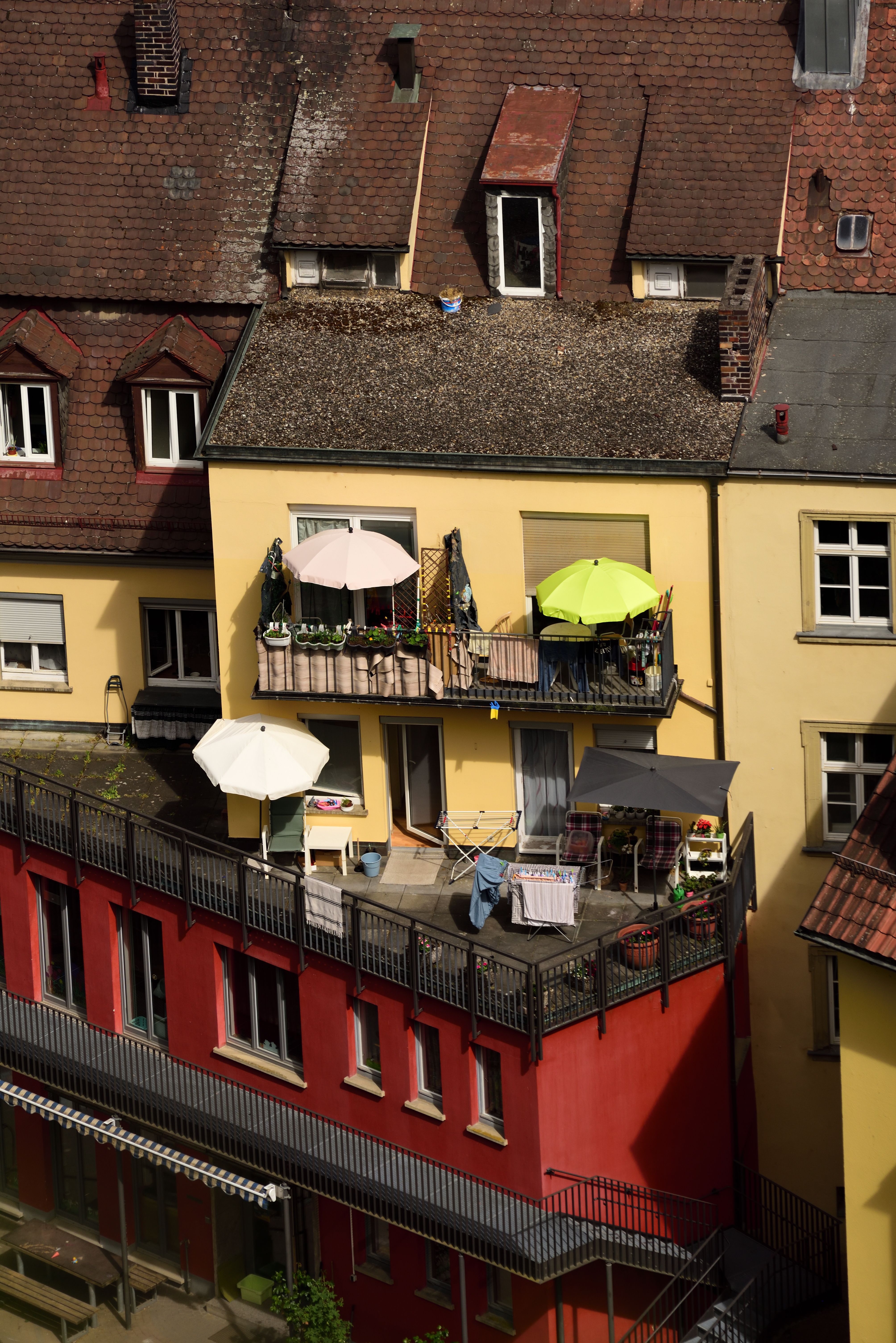 Free Vibrant balconies with sun umbrellas in Würzburg, Germany, capturing summer vibes. Stock Photo