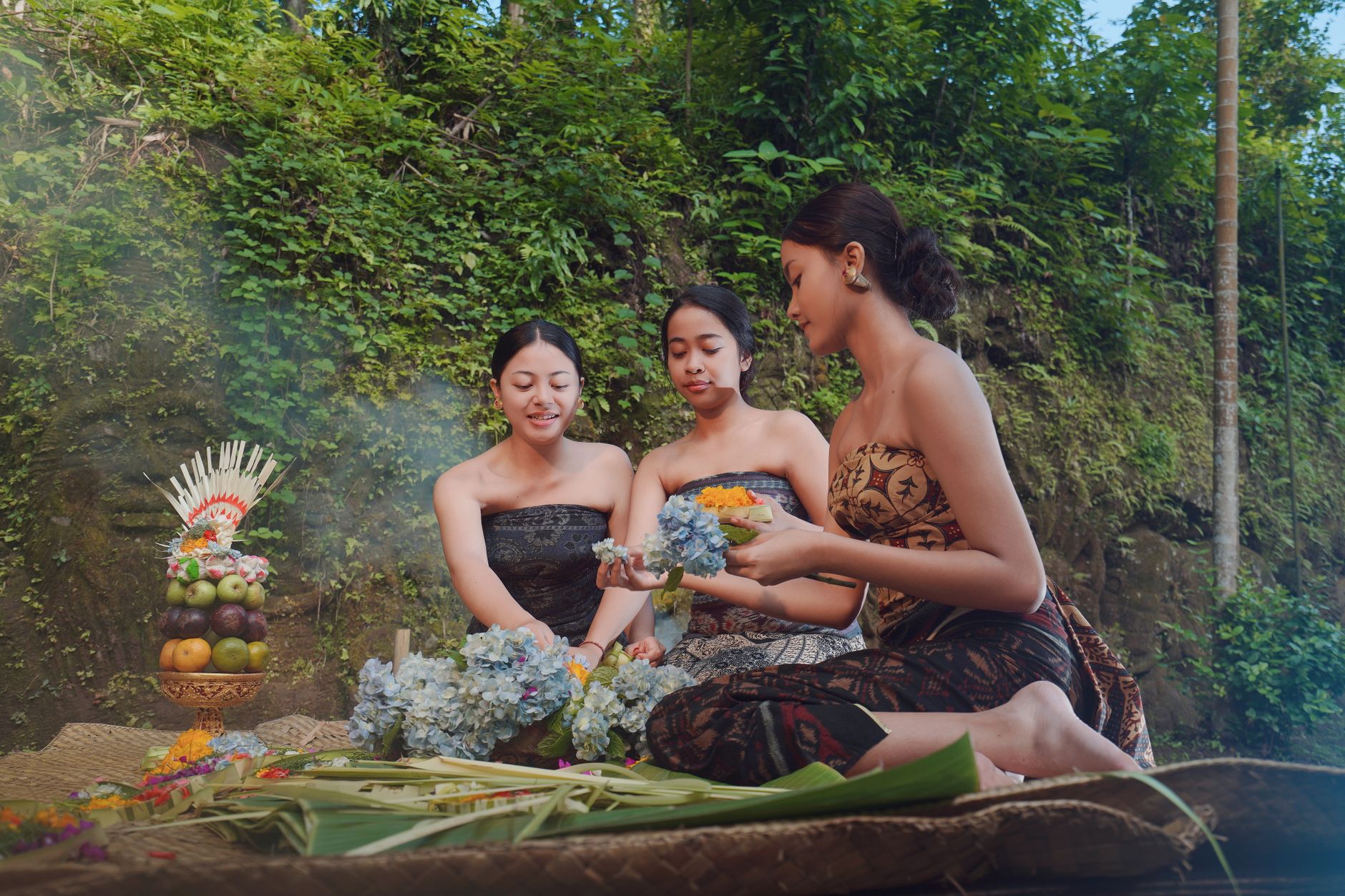 Balinese villagers arranging a traditional cockfight arena, woven bamboo barriers and solemn ceremonial preparations