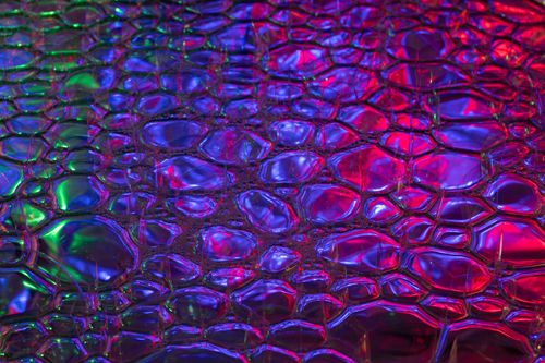 Free Colorful abstract texture with vibrant neon bubbles in electric blue and magenta hues. Stock Photo