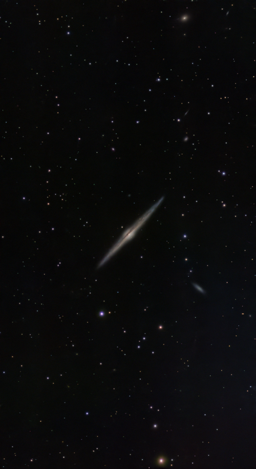 Free Majestic edge-on spiral galaxy surrounded by twinkling stars in deep space. Stock Photo