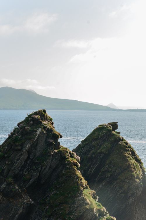 Free Majestic rock formations rise from the sea on the scenic Irish coast under a bright sky. Stock Photo