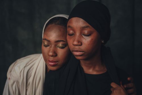 Free Emotive portrait of two African women in close embrace, depicting warmth and connection. Stock Photo