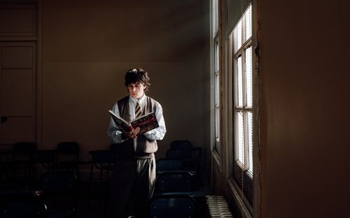 Free A student reads alone in a sunlit classroom in Buenos Aires, Argentina. Stock Photo
