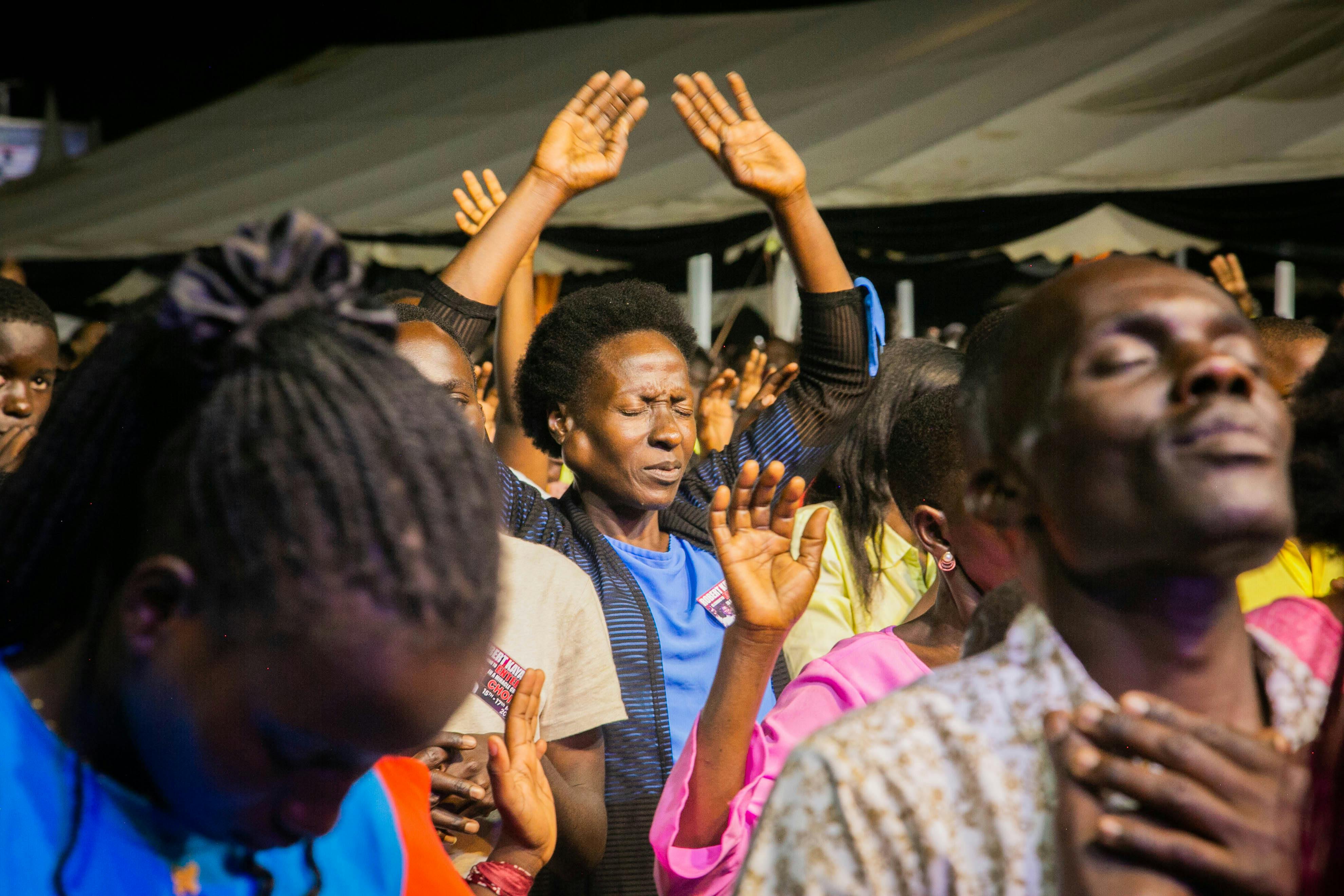 worshippers at Christ Embassy Loveworld Arena raising hands in praise
