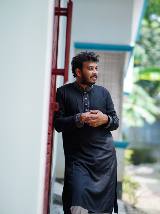 Man in Traditional Attire Standing Outdoors · Free Stock Photo