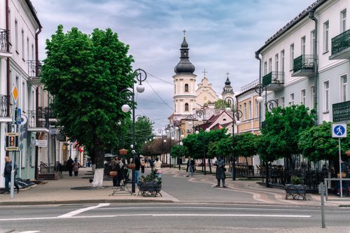 Free Picturesque urban scene with historic architecture and vibrant street life in Pinsk, Belarus. Stock Photo