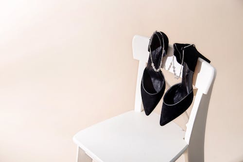 Black High Heel Shoes on the Chair