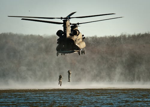 Free Gray Helicopter Above Body of Water Stock Photo