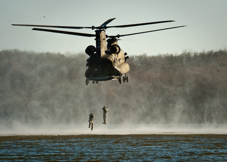 Gray Helicopter Above Body Of Water