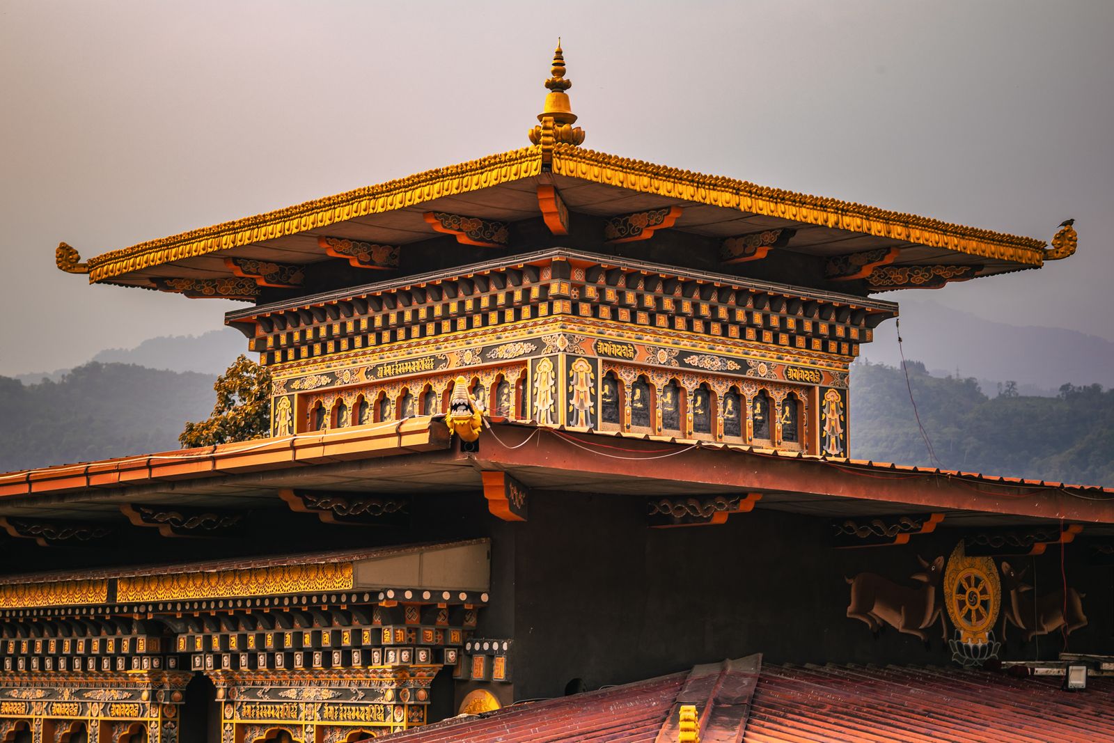 The gilded roof and painted eaves of a Bhutanese temple in the border town of Phuentsholing