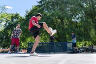 Group of teenagers playing street soccer in a lush Buenos Aires park on a sunny day.