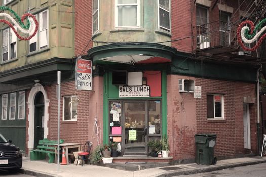 A vintage diner facade on a street corner in Boston's historic North End.