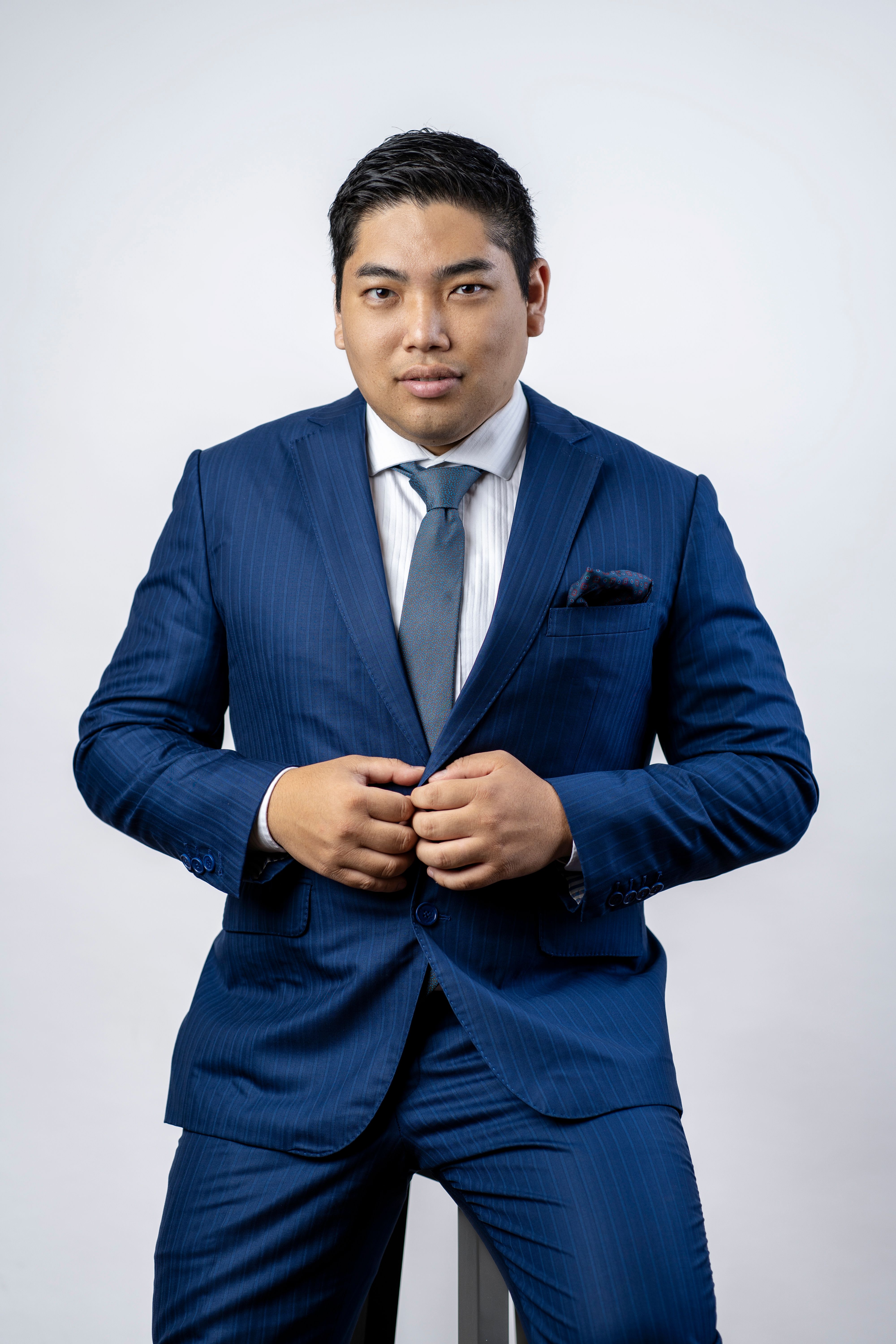 Portrait of a confident man in a blue business suit, ideal for corporate and business-themed content.
