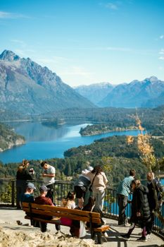 Tourists enjoy a sunny day overlooking the picturesque landscape of San Carlos de Bariloche, Argentina.