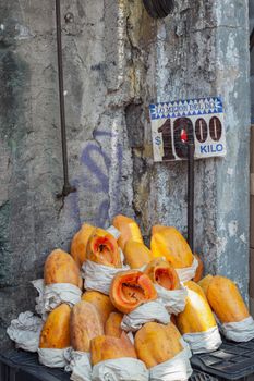 A collection of ripe papayas for sale in a vibrant street market in Mexico City, Mexico.