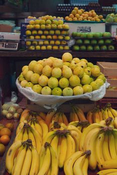 Colorful display of bananas and guavas at a local market in Mexico City.