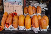 Bright papayas on display at a market stall in Mexico City, showcasing tropical fruit abundance.