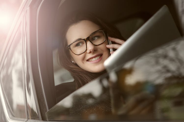 Businesswoman Talking On Phone In Car