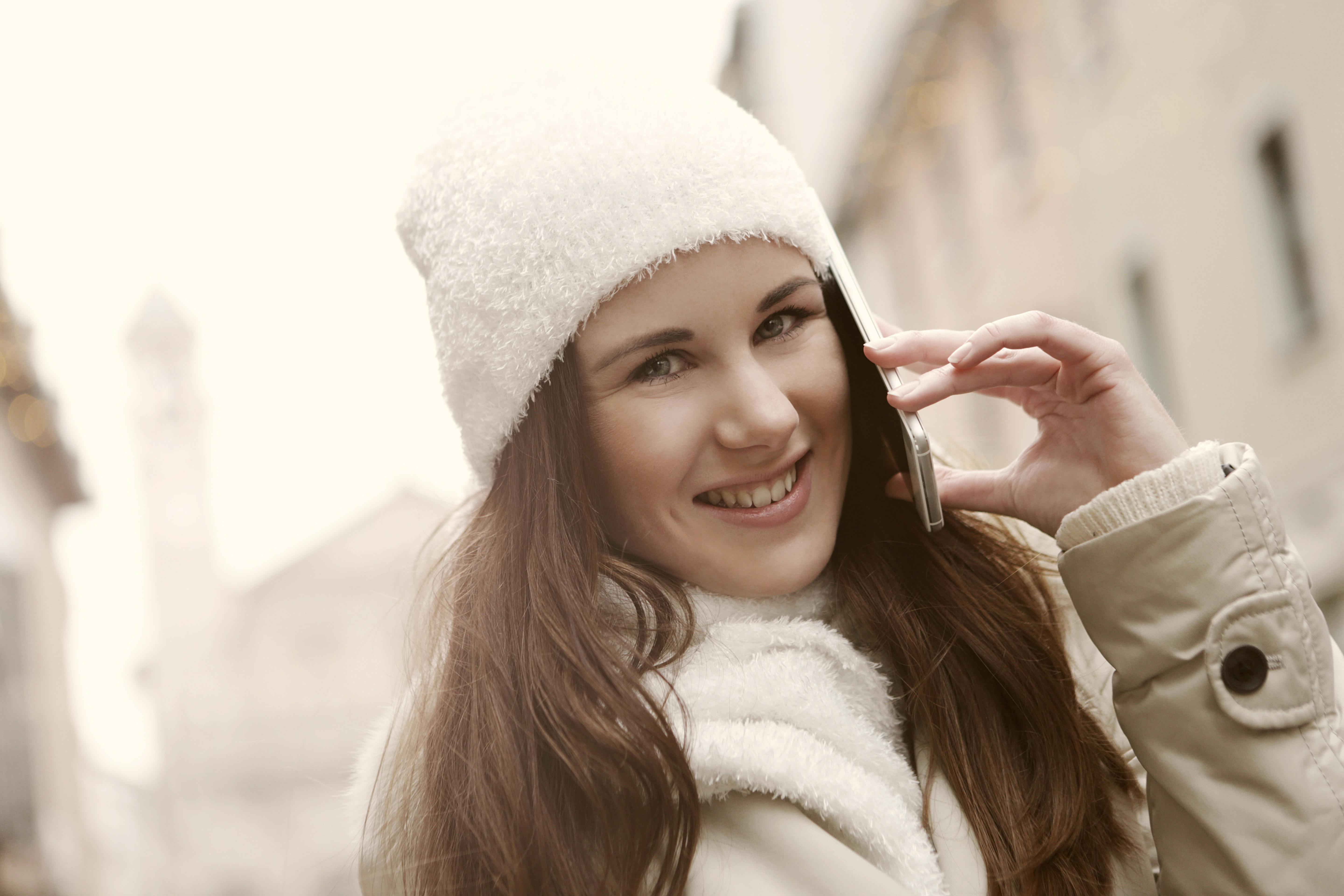 Joyful woman having conversation on smartphone in city · Free Stock Photo