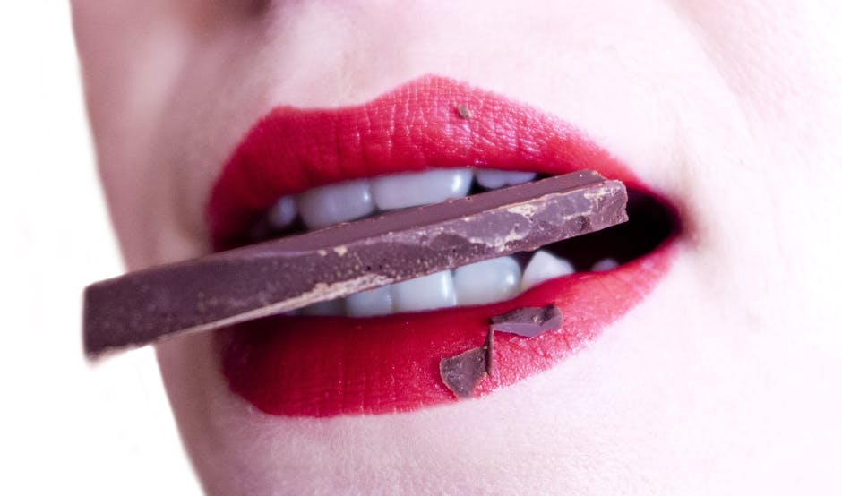 Woman Biting Brown Chocolate