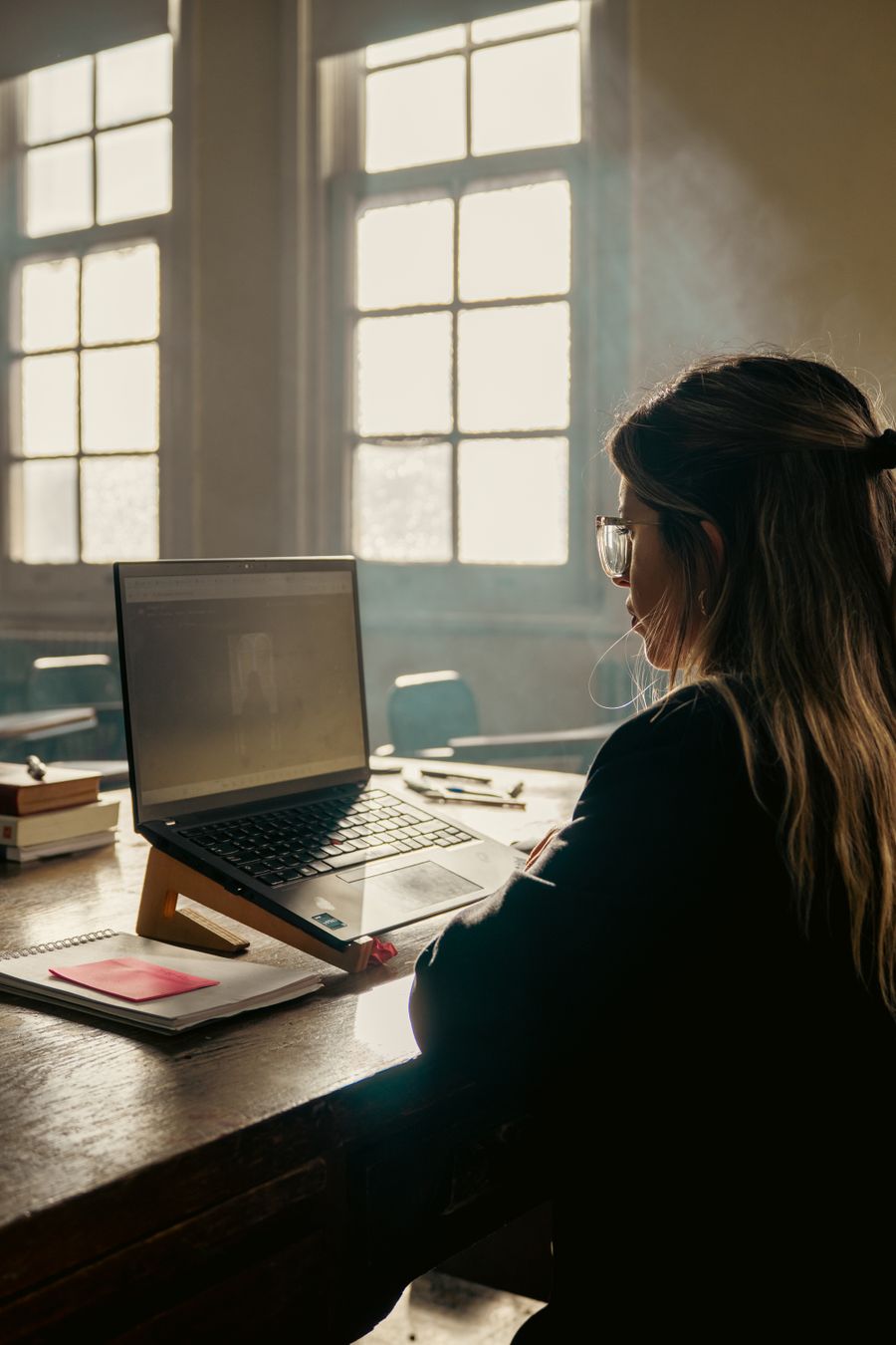 A laptop and notebook set up for an online lesson