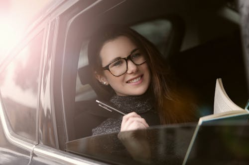 Free Woman in Black Framed Eyeglasses Holding Smartphone Stock Photo