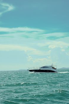 Elegant yacht gliding through turquoise waters under a clear sky.