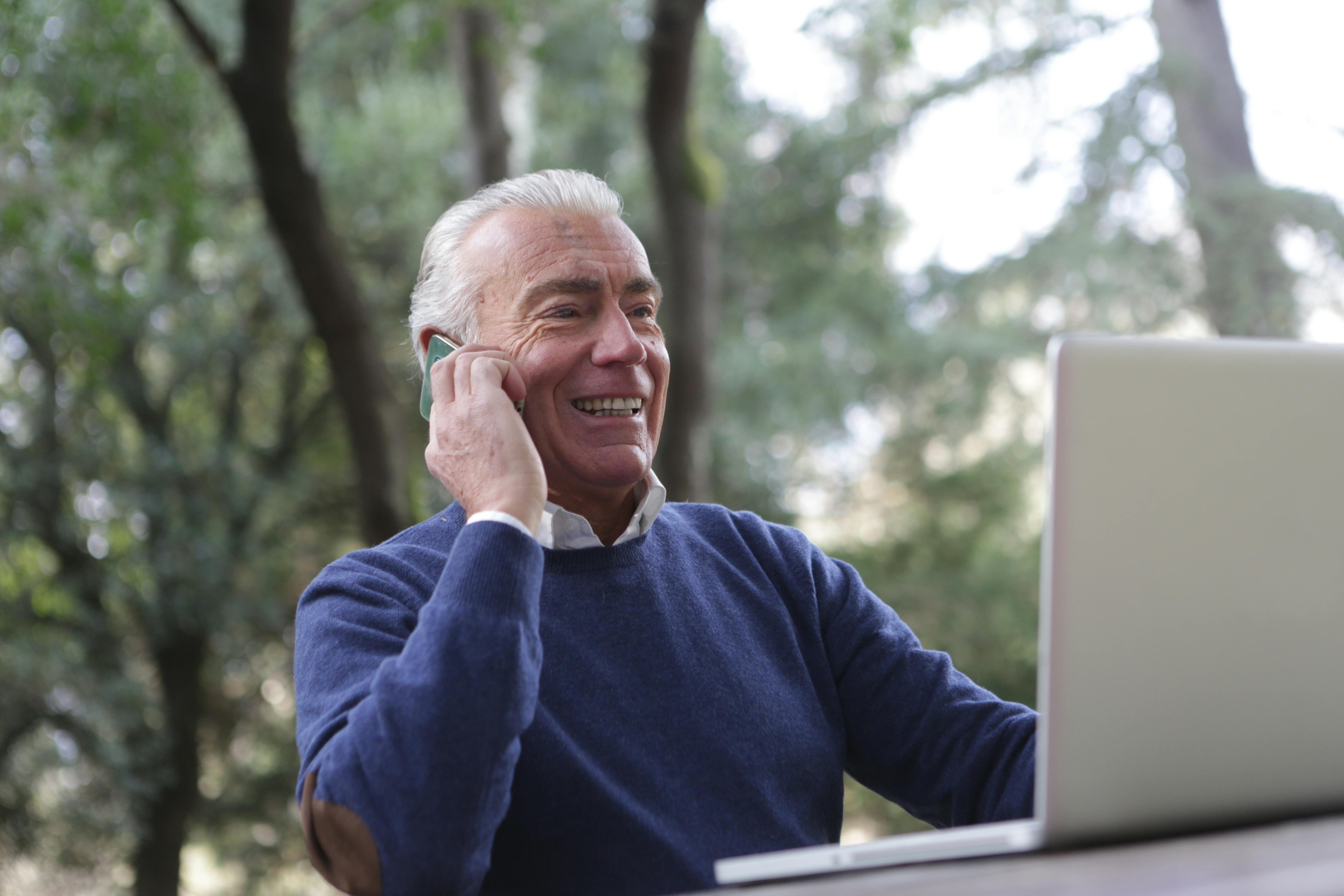 man in blue sweater having a sweet conversation