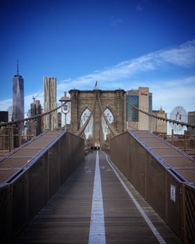 A stunning view of Brooklyn Bridge with Manhattan skyline in the background on a clear winter day.