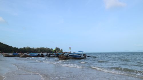 Free Traditional fishing boats anchored on a serene beach under a clear blue sky. Stock Photo
