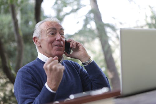 Free Man in Blue Sweater Received a Good New Stock Photo