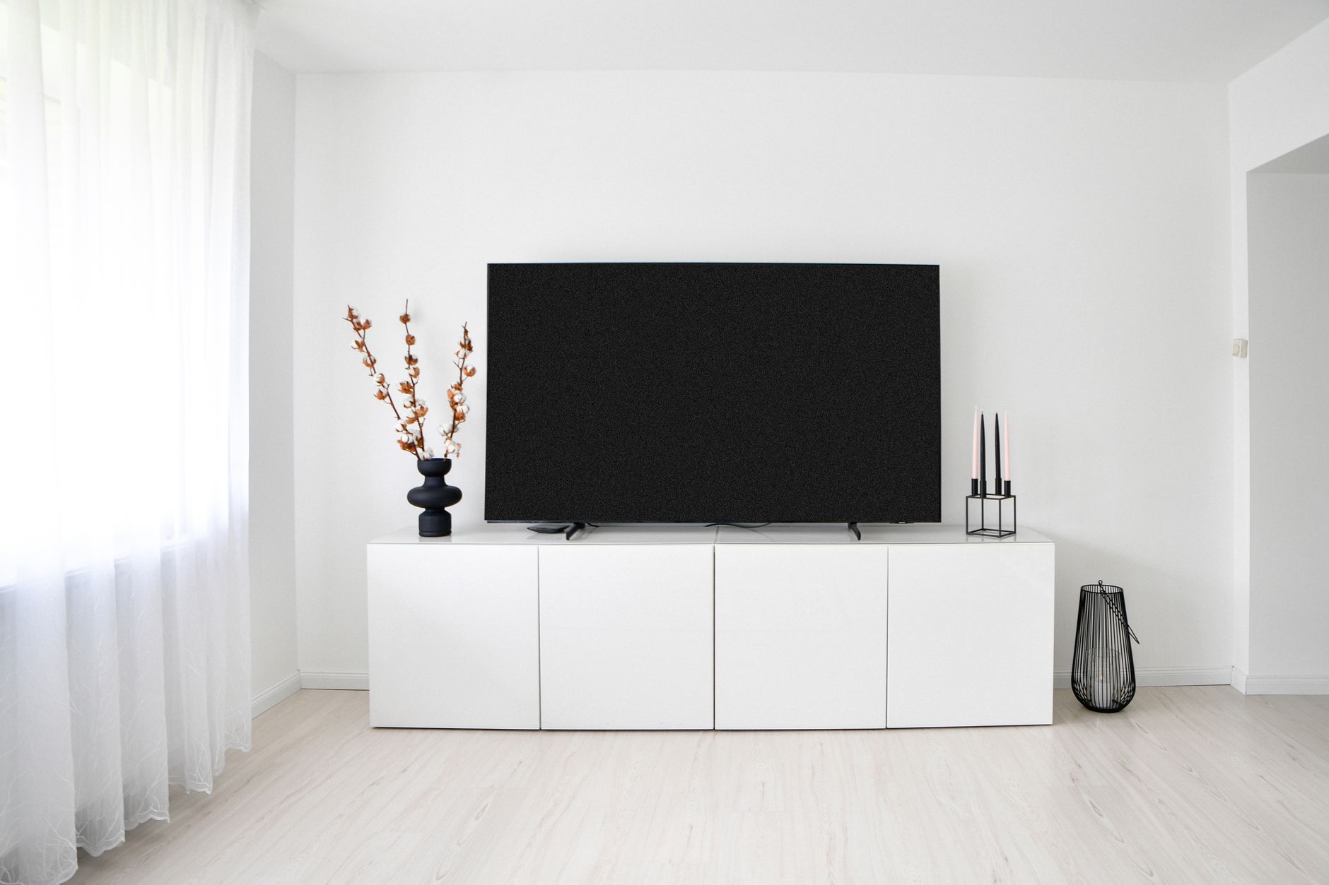 scandinavian apartment organization with smart home gadgets A sleek and minimalist Scandinavian living room with white decor and electronics.