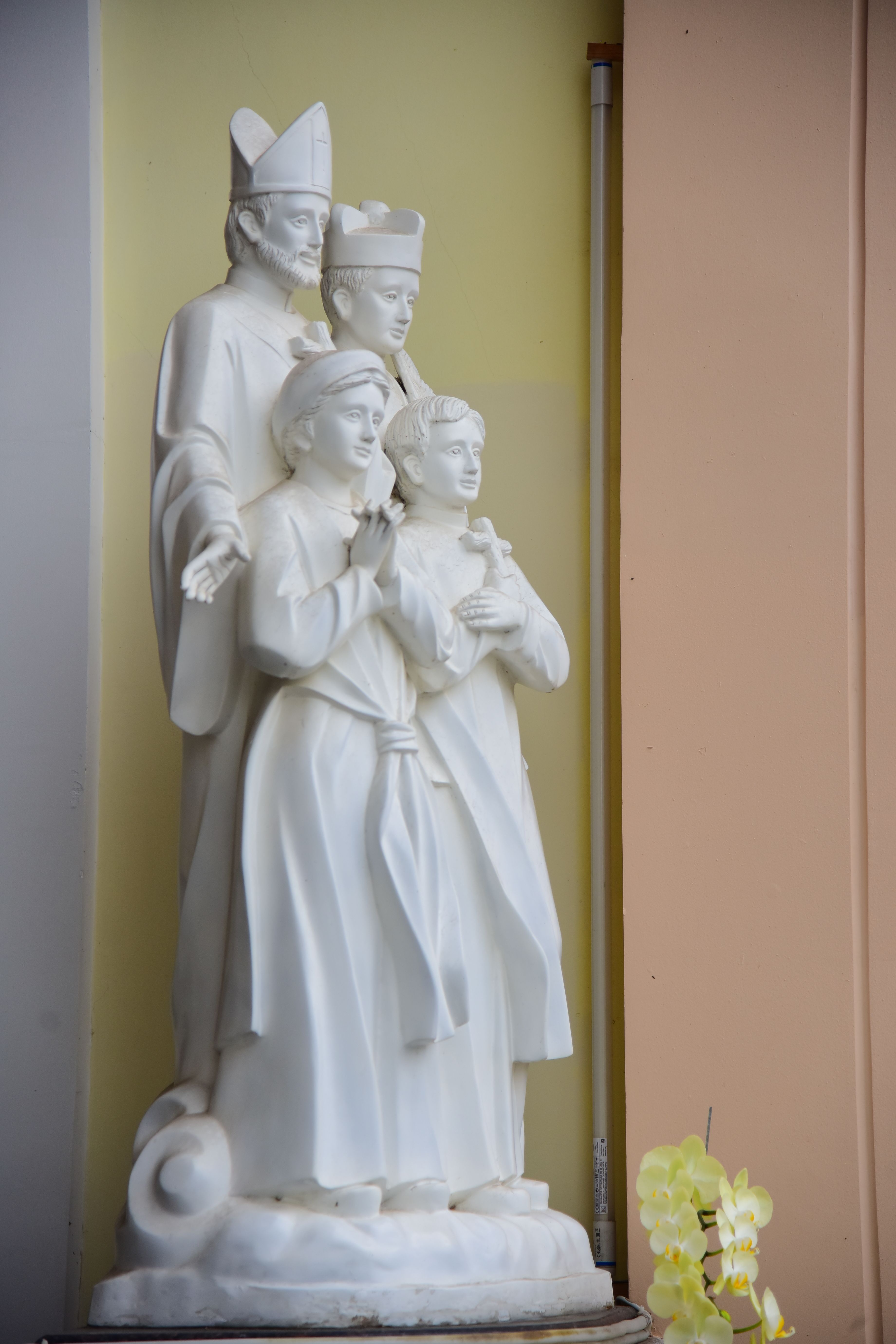 Elegant marble statues of religious figures in church interior
