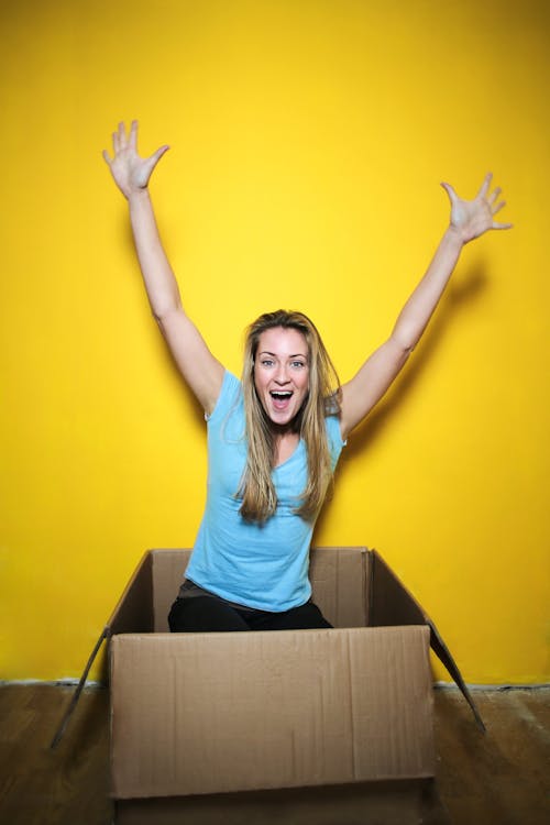 Woman in Blue Shirt Raising Her Hands