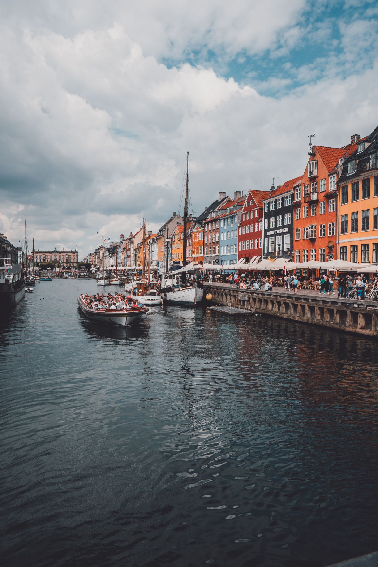 Brightly painted townhouses and moored boats lining the Nyhavn canal in Copenhagen