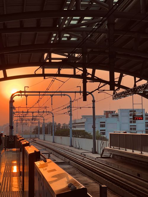 Free Captivating sunset view from a metropolitan train station, capturing urban architecture and warm hues. Stock Photo