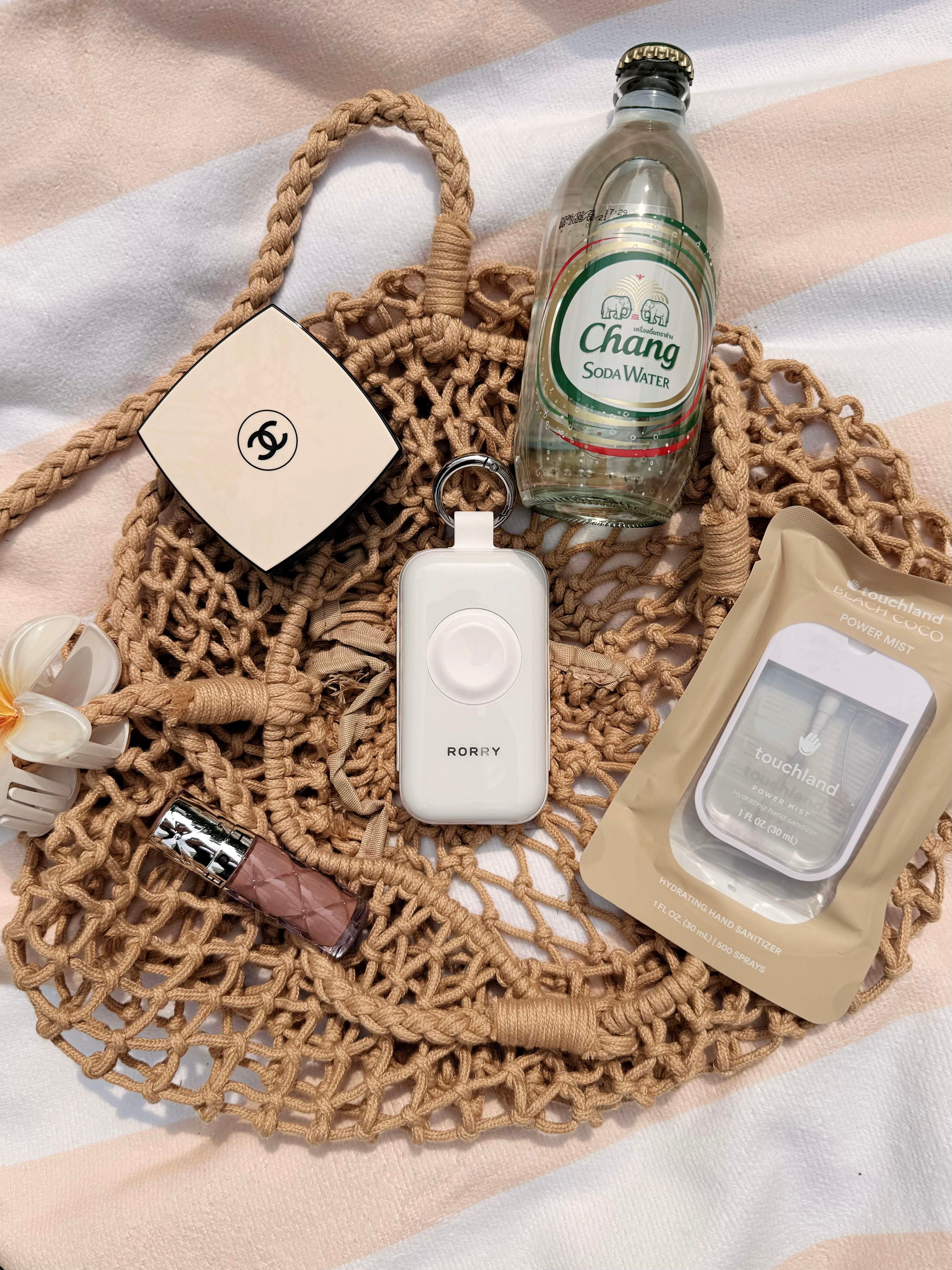 Discover summer beach essentials in a stylish flat lay featuring tech gadgets and accessories.