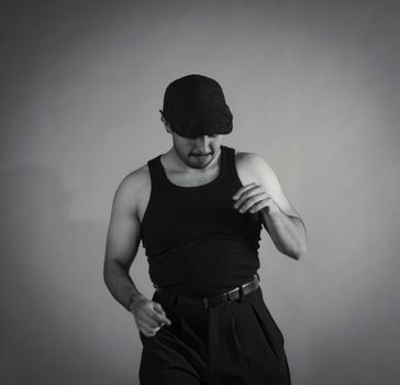 Artistic black and white portrait of a man dancing in black attire.