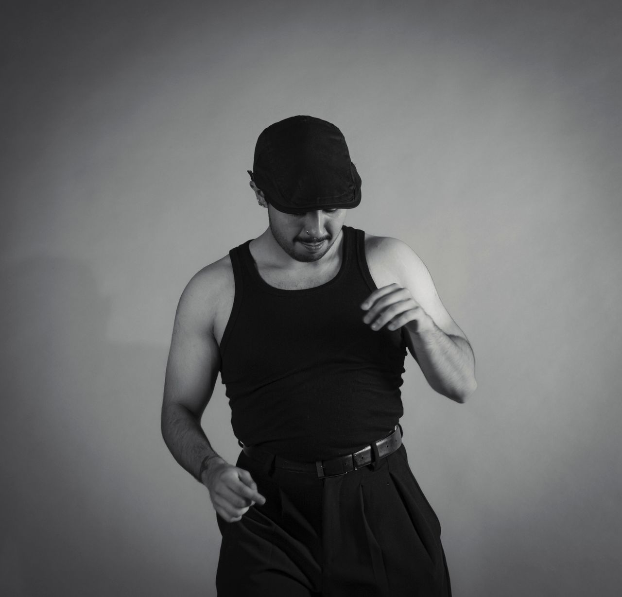 artistic black and white portrait of a man dancing in black attire