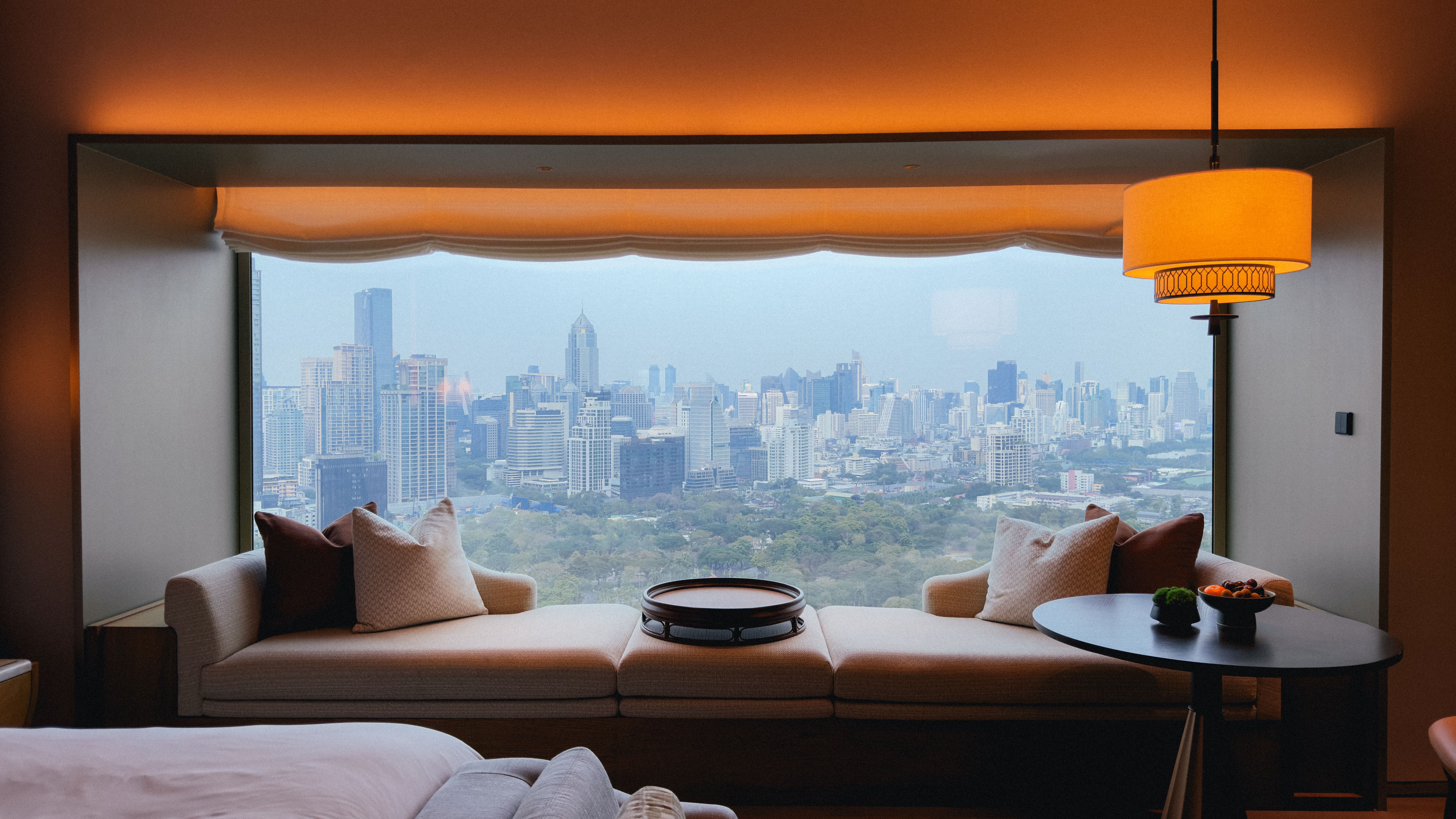 Luxury hotel room overlooking a city skyline, an example of lower-cost international five-star stays